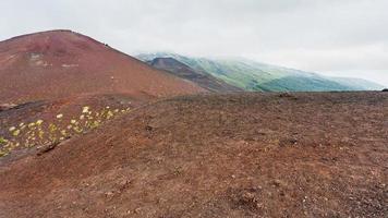 cloud over volcanic hills on Etna Mount photo