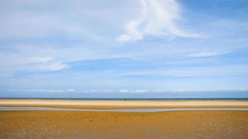 blue sky over wet yellow sand beach Le Touquet photo