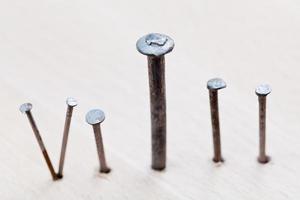 different nails into wooden board photo