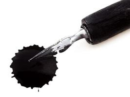 drawing pen with metal nib and black ink blot photo