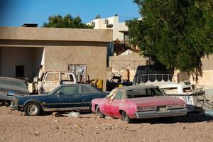 Sharm El Sheikh, Egypt - January 21, 2021 - Dump of old American, Japanese cars of the twentieth photo