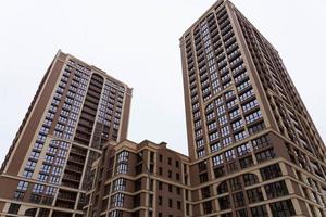MINSK, BELARUS - DECEMBER 26, 2020, Angle view of textured background of modern multi-story glass skyscraper. photo