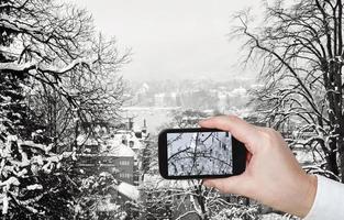 tourist taking photo of Zurich skyline in winter