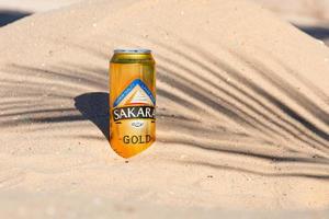 Sharm El Sheikh, Egypt - January 21, 2021 - SAKARA GOLD beer in a metal can, a beer can on the background of the Desert. photo