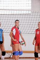 girls playing volleyball indoor game photo