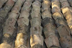 Old tiled roof arranged in parallel rows. Background. Selective focus. photo