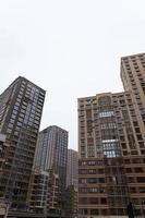 MINSK, BELARUS - DECEMBER 26, 2020, Angle view of textured background of modern multi-story glass skyscraper. photo