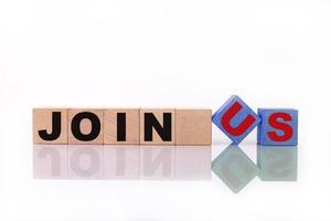 JOIN US word, text, written on wooden cubes, building blocks, over white background with reflection. photo