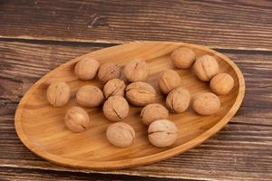 IRipe walnuts in the shell, the theme of healthy eating, vegetarianism, raw food diet. photo