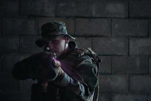 soldier in action aiming  on laser sight optics photo