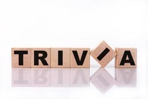 TRIVIA word, text, written on wooden cubes, building blocks, over white background with reflection. photo