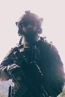 War concept. A bearded soldier in a special forces uniform fighting an enemy in a forest area. Selective focus photo