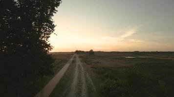 Sun rise shines over a landscape of fields and trees video