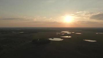 Sun rise shines over a landscape of fields and trees video