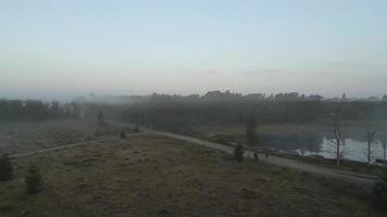 Sun light shines over a foggy field video