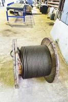wooden reel with steel rope in mechanical shop photo