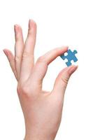 female arm holding puzzle piece photo