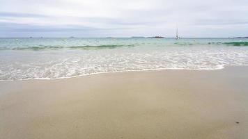 view of sea from sand beach in Perros-Guirec town photo