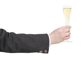 side view of champagne glass in businessman hand photo