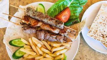 above view of skewers with various arabian kebabs photo