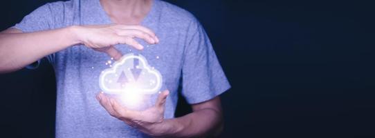 Man holding virtual cloud computing on hand with connection line.Cloud computing is system for sharing download and upload big data information. photo