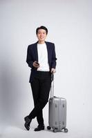 Young business man wearing a suit posing on a white background photo