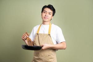 man holding a pan on the background photo