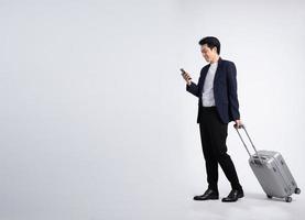 Young business man wearing a suit posing on a white background photo