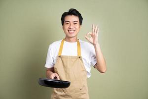 man holding a pan on the background photo