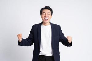 Young business man wearing a suit posing on a white background photo