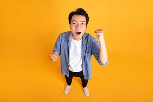 image of asian man posing on a yellow background photo