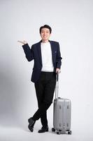 Young business man wearing a suit posing on a white background photo