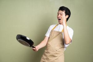 man holding a pan on the background photo