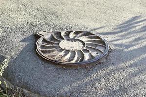 Iron manholes on the road in the city. photo