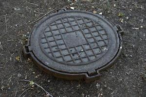 Iron manholes on the road in the city. photo