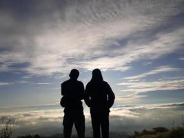 Silhouette image on the top of the mountain photo