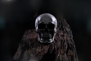 Halloween human skull on an old wooden table over black background. Shape of skull bone for Death head on halloween festival which show horror evil tooth fear and scary with fog smoke, copy space photo