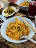 famous traditional khao soi in lana chiang mai yellow spicy taste noodle soup style. photo
