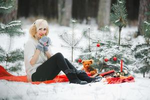 Cute girls have fun in the frozen park. Woman in a knitted sweater.the girl's hands froze photo