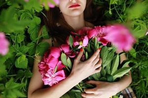 Bouquet of Peony. beautiful young woman lies among peonies. Holidays and Events. Valentine's Day. Spring blossom. photo