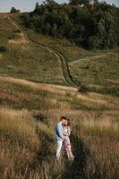 loving couple hold hands and hugging outside in the field at summer. Concept of love and family. copy space. selective focus photo