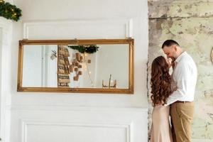 young beautiful man and woman are celebrating Christmas. A loving couple enjoy each other on New Year's Eve. photo