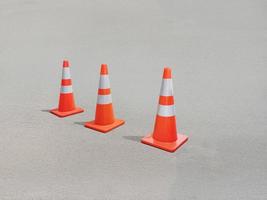 Bright orange traffic cones line the concrete floor. photo