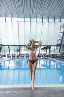 Portrait of beautiful woman relaxing and enjoying in swimming pool. photo