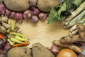 coriander, bay leaves, potatoes, lemongrass leaves, with a wooden texture empty space. photo