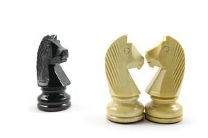 Love triangle, jealousy and sharing of loved ones. Illustration with simple chess horse. photo