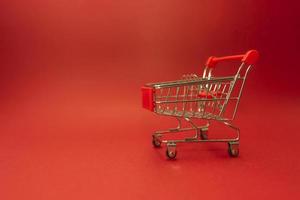 A shopping truck standing on a red background photo