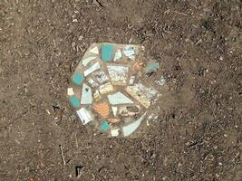 colorful mosaic stone tile in the ground or dirt photo