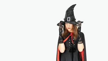 Beautiful girl in witch costume and witch hat is over isolated white background photo