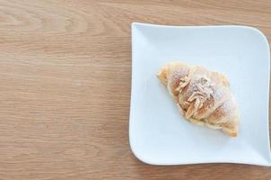 The croissant is placed on a plate ready to eat. photo